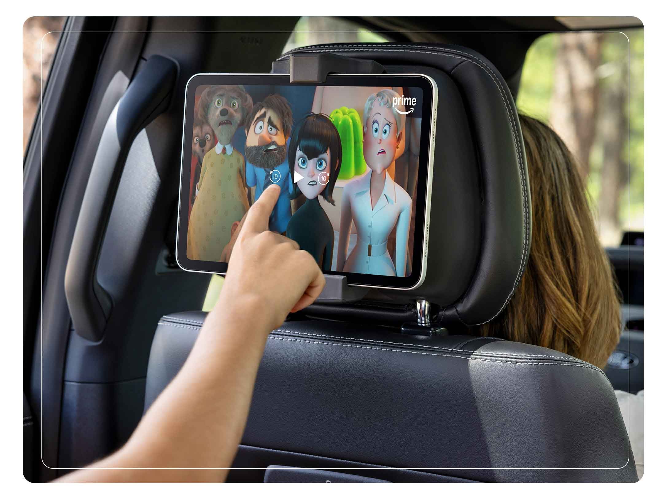 Passenger using a tablet in the available second-row digital device holder in a 2025 Ford Expedition® SUV